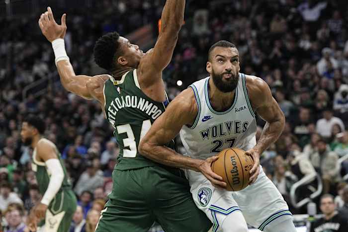 Feb 8, 2024; Milwaukee, Wisconsin, USA; Minnesota Timberwolves center Rudy Gobert (27) looks to shoot around Milwaukee Bucks forward Giannis Antetokounmpo (34) during the second quarter at Fiserv Forum.